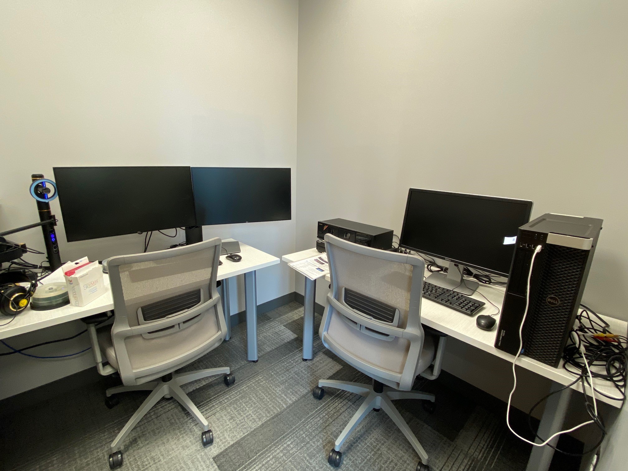 Editing studio featuring two computers with a microphone